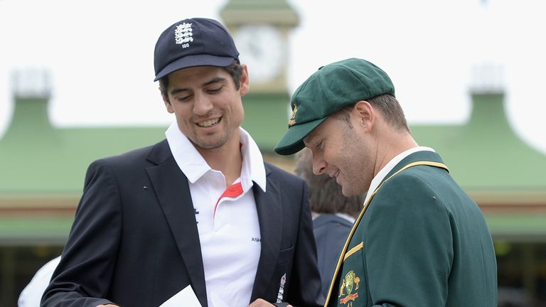 Alastair Cook and Michael Clarke study the teamsheets at Sydney
