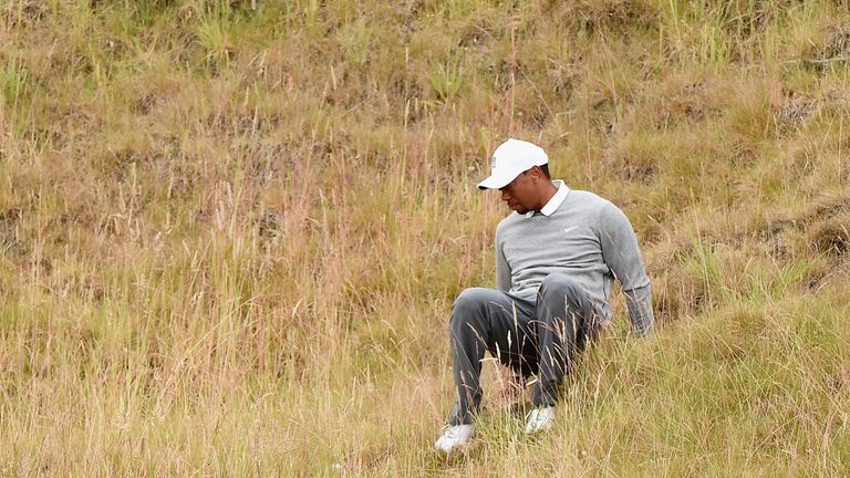 Tiger Woods slips in the rough
