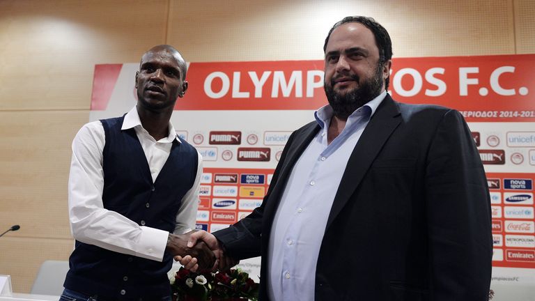 Eric Abidal (L) shakes hands with Olympikos president, Vangelis Marinakis during a press conference at Karaiskaki Stadium