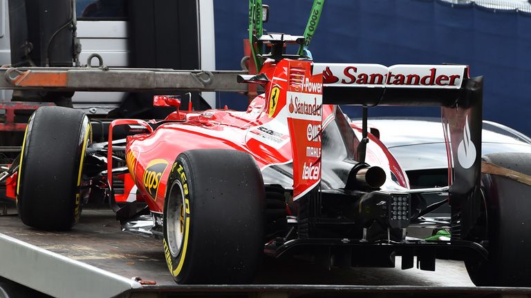 Sebastian Vettel's Ferrari SF15-T is recovered after breaking down in Friday morning practice