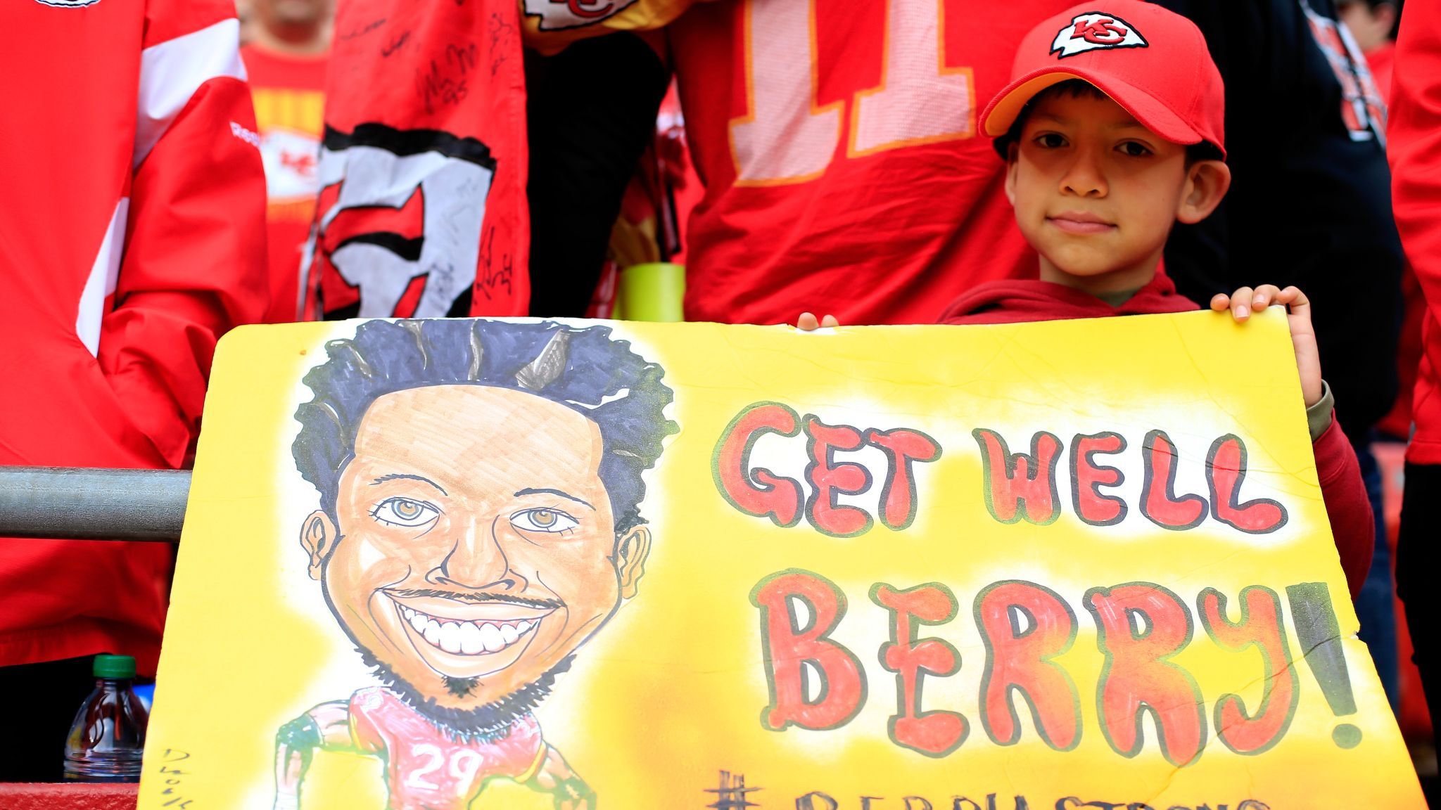 A Kansas City Chiefs fan, dressed in the jersey of Kansas City Chiefs  defensive back Eric Berry (29), stands next to a Oakland Raiders fan during  the first half of an NFL