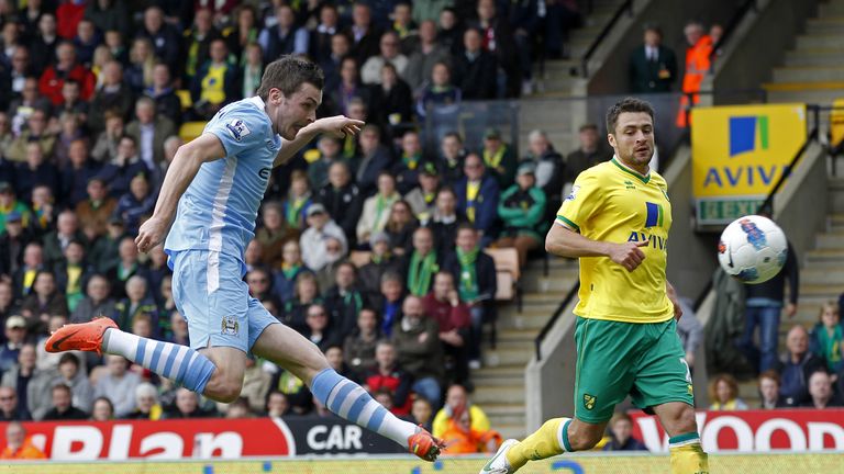 Adam Johnson scores his goal during the English Premier League football match between Norwich City and Manchester City.