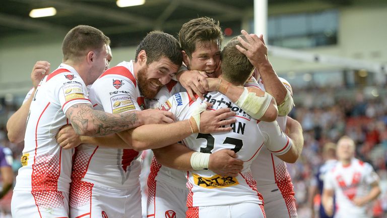 Adam Quinlan celebrates with his St Helens team-mates after scoring a try against Huddersfield