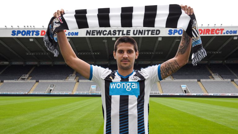 Aleksandar Mitrovic holds a Newcastle United scarf at St James' Park after signing for the club