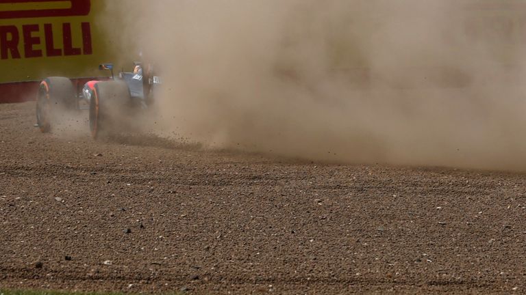 Fernando Alonso goes through the gravel during Friday practice for the British GP