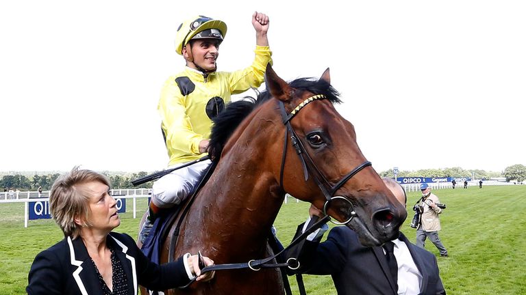 Andrea Atzeni punches the air after guiding Postponed to a narrow victory in the King George