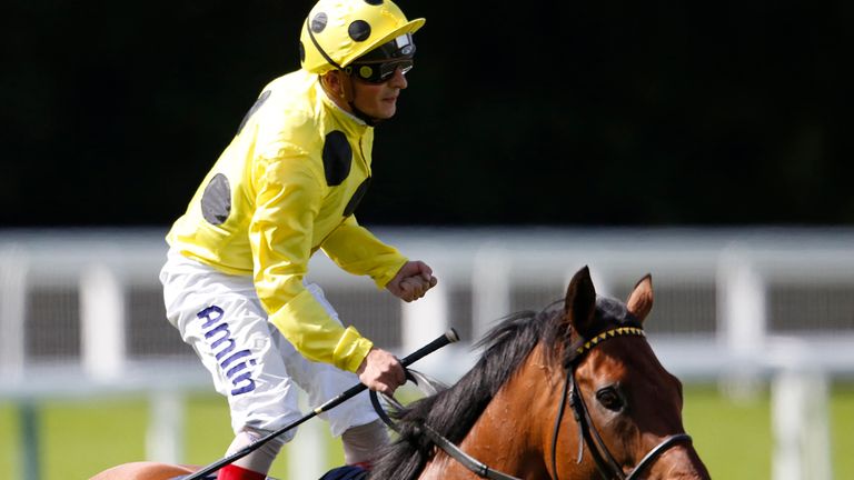 Andrea Atzeni celebrates after riding Postponed to victory in the King George at Ascot