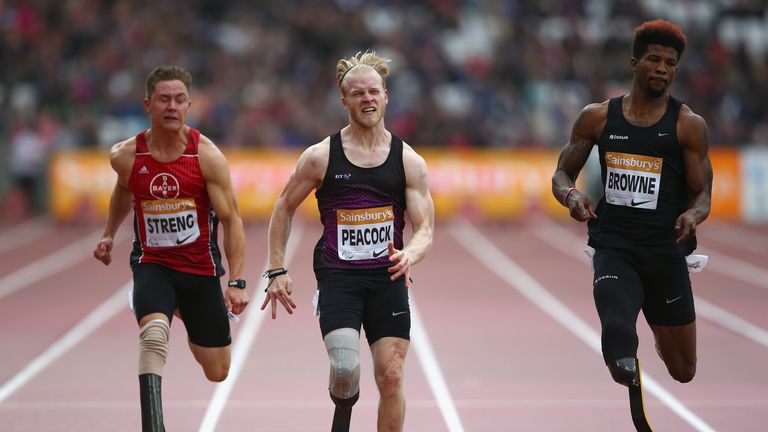 Richard Browne of United States (r) leads Jonnie Peacock of Great Britain (m) on his way to winning the Men's 100m T44 race during Anniversary Games