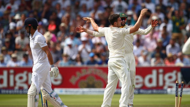 Mitchell Marsh and Nathan Lyon of Australia celebrate the dismissal of England captain Alastair Cook during day three of the second Ashes Test