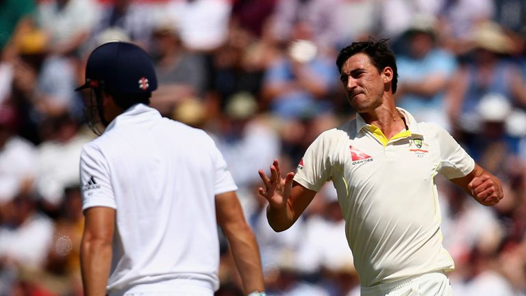 Mitchell Starc of Australia celebrates after taking the wicket of Alastair Cook of England