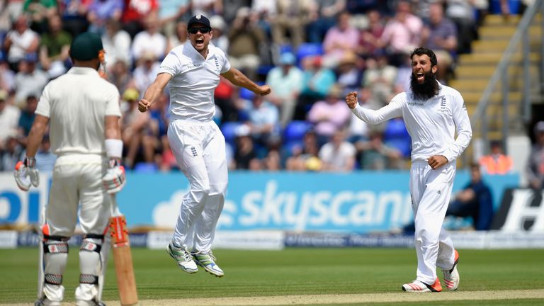 Captain Alastair Cook and bowler Moeen Ali celebrate after dismissing Australia batsman David Warner