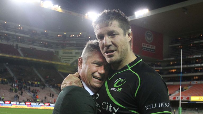 Bakkies Botha of the World XV hugs Springbok coach Heyneke Meyer