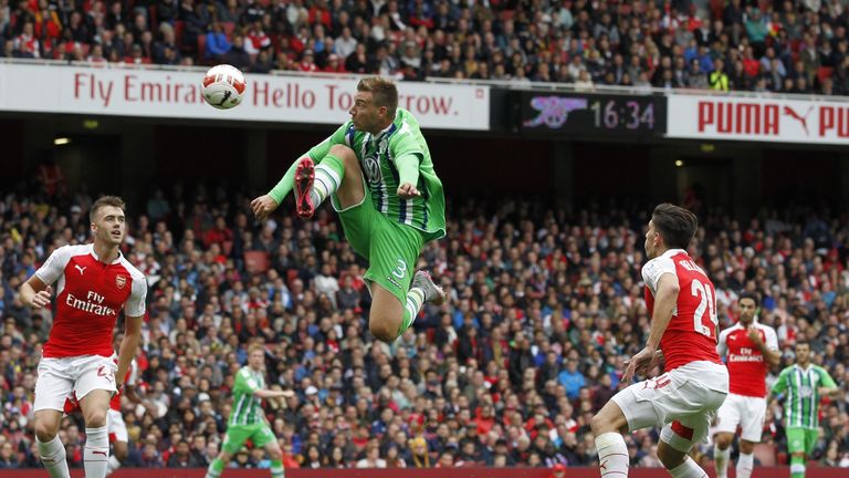 Wolfsburg striker Nicklas Bendtner jumps to control the ball