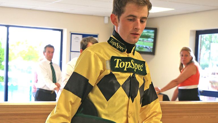 Jockey Brian Toomey weighs out before riding at Southwell Racecourse.