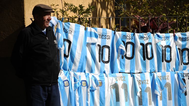 A peddler offers Argentine football  Lionel Messi's #10 jerseys and Carlos Tevez's #11s at a street near Colon stadium in Santa Fe, Argentina in July 2011