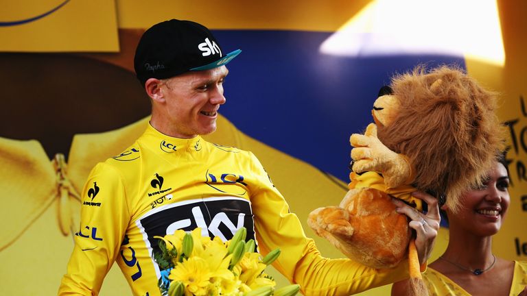 Chris Froome of Great Britain and Team Sky celebrates retaining the overall leaders yellow jersey at the finish at the finish of th