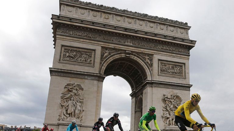 Britain's Chris Froome wearing the overall leader's yellow jersey cycles past the Arc de Triomphe