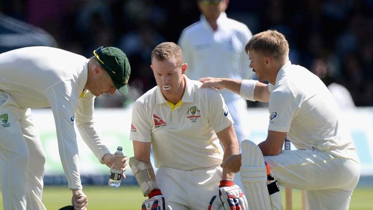Chris Rogers (middle) is comforted by Brad Haddin (R) and David Warner (L) at Lord's