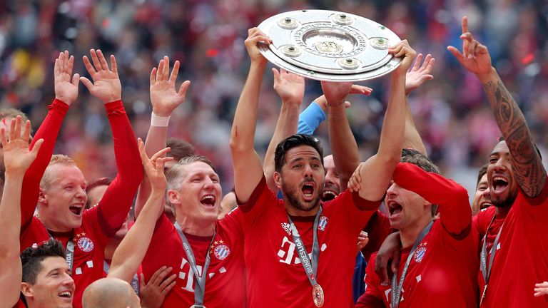 Claudio Pizarro of Bayern Munich and teammates celebrate with the Bundesliga trophy
