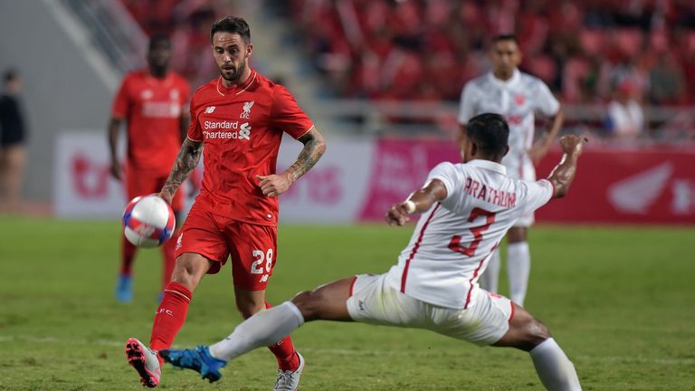 Liverpool player Danny Ings (L) battles for the ball with Prathum Chuthong (R) of Thailand All Stars at Rajamangala stadium in Bangkok on July 14, 2015.  