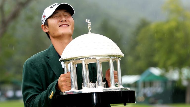 Danny Lee of New Zealand poses with the trophy after winning on the second hole of a sudden death playoff at the Greenbrier Classic