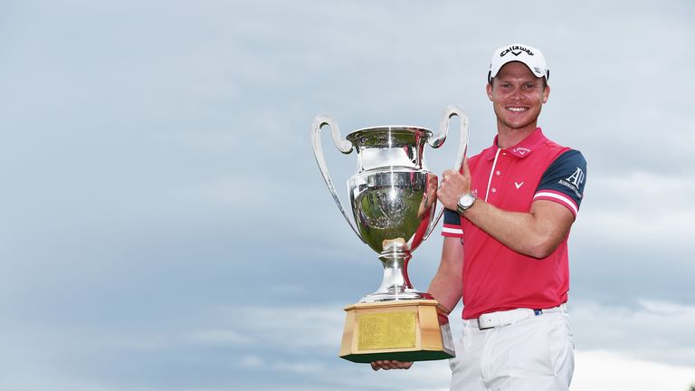 CRANS-MONTANA, SWITZERLAND - JULY 26:  Danny Willett of England holds the trophy after winning the Omega European Masters at Crans-sur-Sierre Golf Club on 