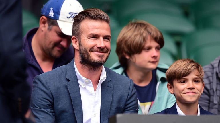 David Beckham and his son Romeo await the start of the Andy Murray match