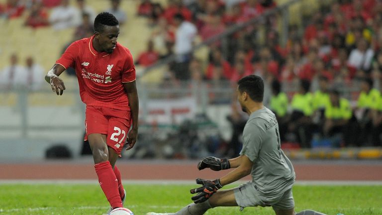 Divock Origi (L) shoots at Malaysia's goalkeeper Khairul Azhan Khalid