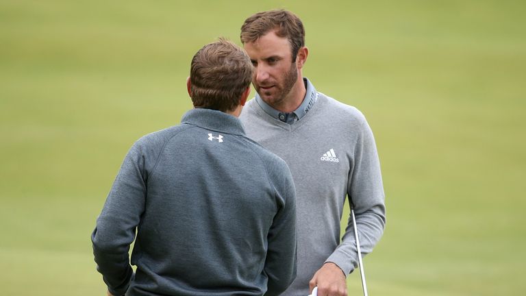 Dustin Johnson and Jordan Spieth of the United States shake hands on the 18th green 