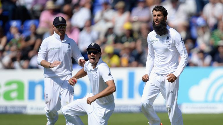 England captain Alastair Cook and Moeen Ali celebrate dismissing Steven Smith of Australia during day two of the 1st Investec Ashes Test