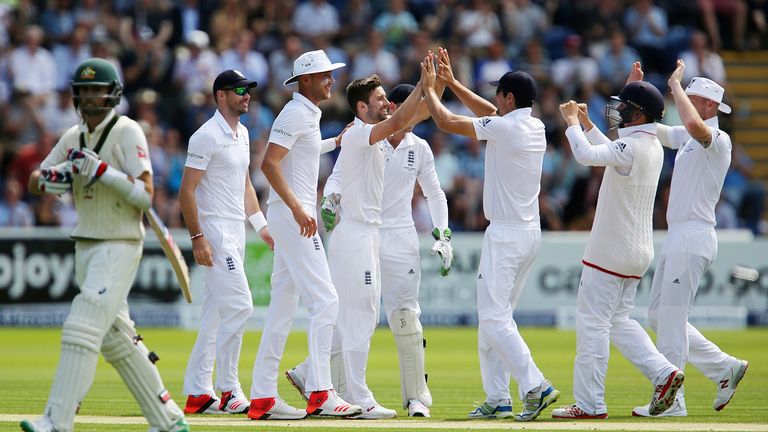 England's players congratulate Mark Wood after he took the wicket of Australia's Nathan Lyon