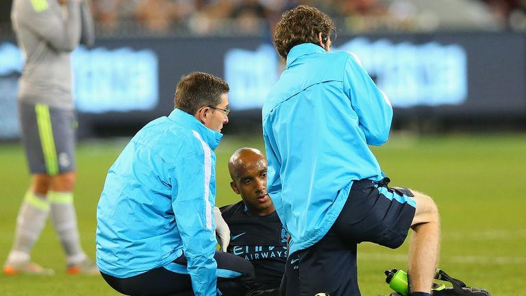 Fabian Delph of Manchester City is attended to by trainers during the International Champions Cup match between Real Madrid and Manchester City