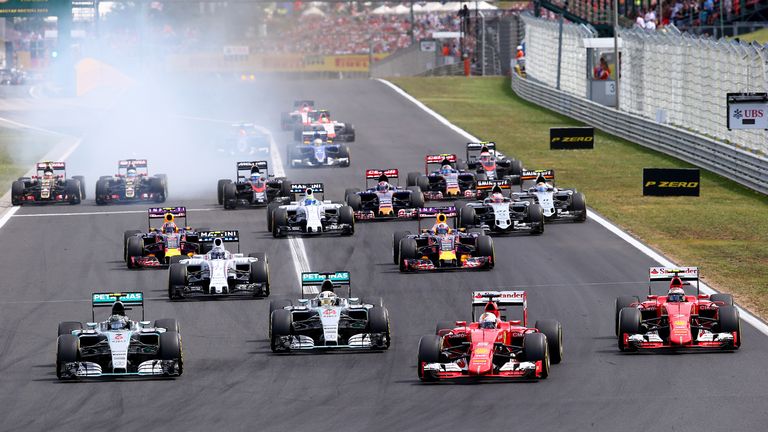 BUDAPEST, HUNGARY - JULY 26:  Sebastian Vettel of Germany and Ferrari leads Nico Rosberg of Germany and Mercedes GP, Lewis Hamilton of Great Britain and Me