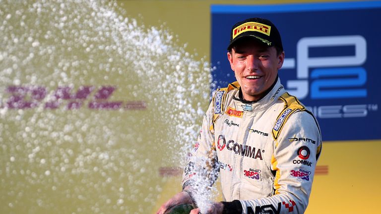 Jolyon Palmer celebrates on the podium after victory in Russia