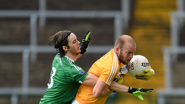 Tiarnan Daly gets to grips with Antrim's Sean McVeigh