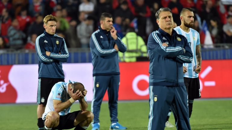 Argentina's coach Gerardo Martino (2-R),  defenders Nicolas Otamendi (R) and Pablo Zabaleta (L, bottom) after losing Copa America final 