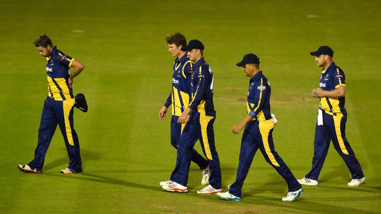Glamorgan captain Jacques Rudolph (2 r) and team mates leave the field after losing the NatWest T20 Blast against Gloucestershire