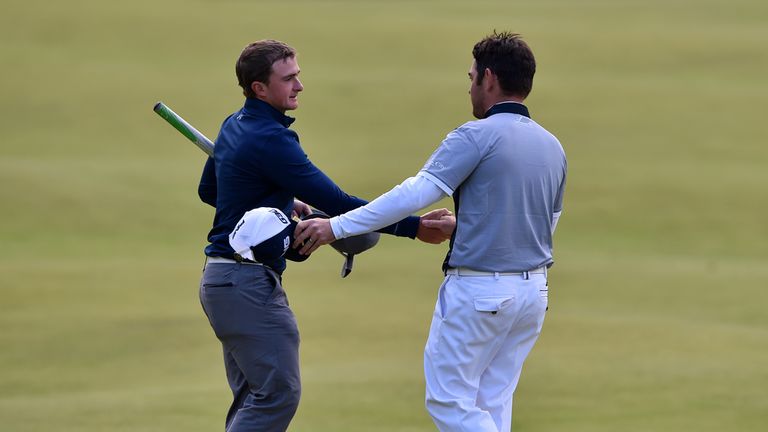 Ireland's Paul Dunne and South Africa's Louis Oosthuizen shake hands on the 18th during day four of The Open Championship 2015 at St Andrews, Fife.