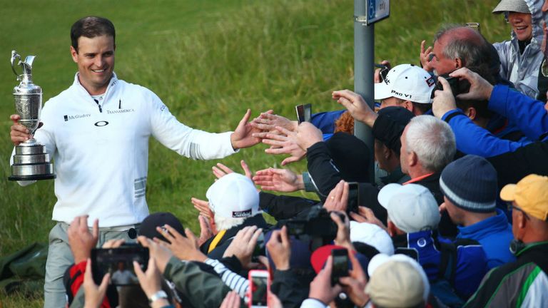 Zach Johnson holds the Claret Jug as he celebrates with spectators after winning the 144th Open