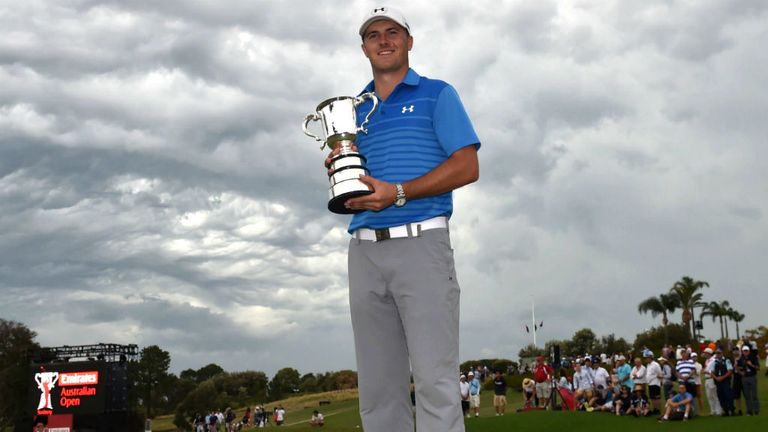 Jordan Spieth of the US holds up the trophy after winning the Australian Open in Sydney