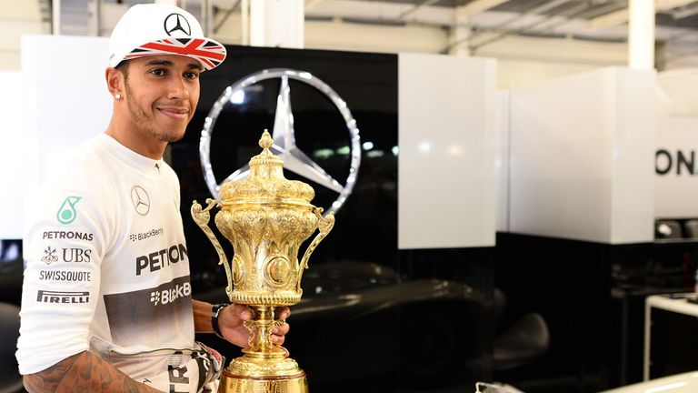 Hamilton with the winner's trophy after the 2014 British GP