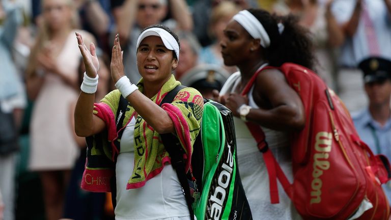 Britain's Heather Watson (L) applauds the crowd as she leaves the court with Serena Williams following their women's singles third round match at Wimbledon