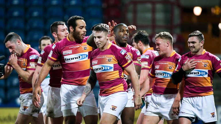 Huddersfield's Jamie Ellis (centre) is congratulated on his try by team-mates.