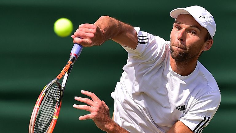 Croatia's Ivo Karlovic returns to France's Jo-Wilfried Tsonga during their men's singles third round match on day six of Wimbledon 2015