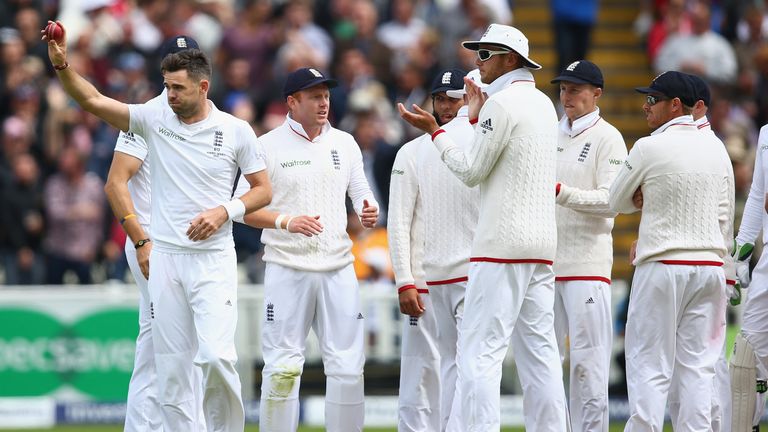 James Anderson (left) of England raises the match ball