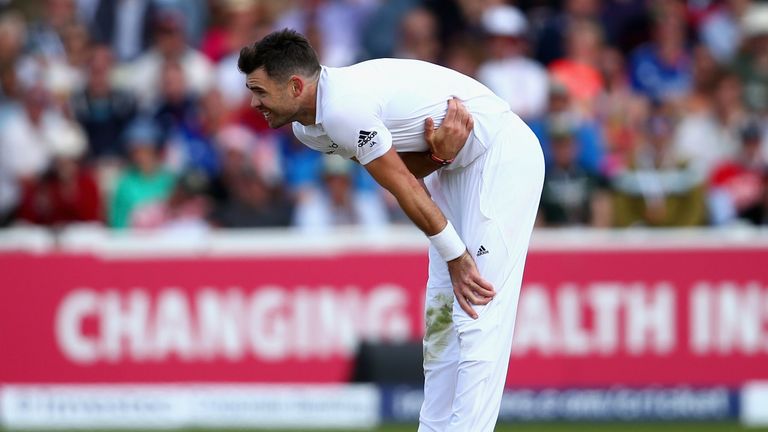 James Anderson of England holds his side