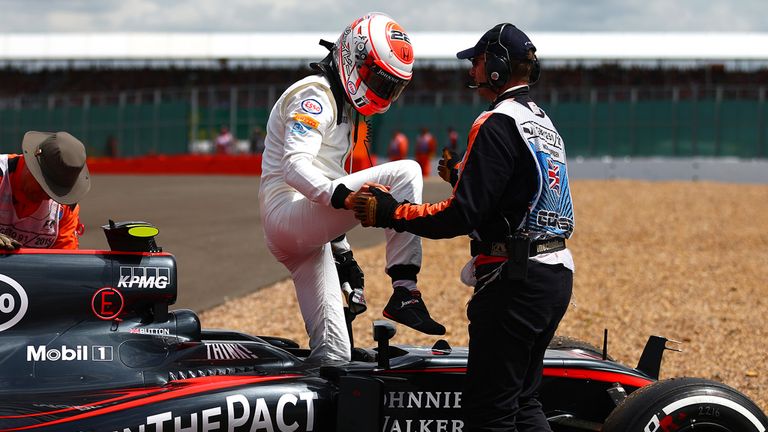 Jenson Button of Great Britain and McLaren Honda climbs out of his car after retiring in the British Grand Prix
