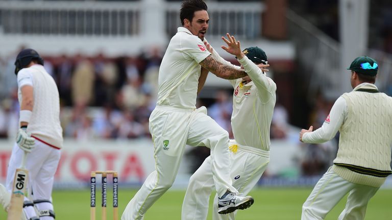 Mitchell Johnson of Australia celebrates after taking the wicket of Joe Root 