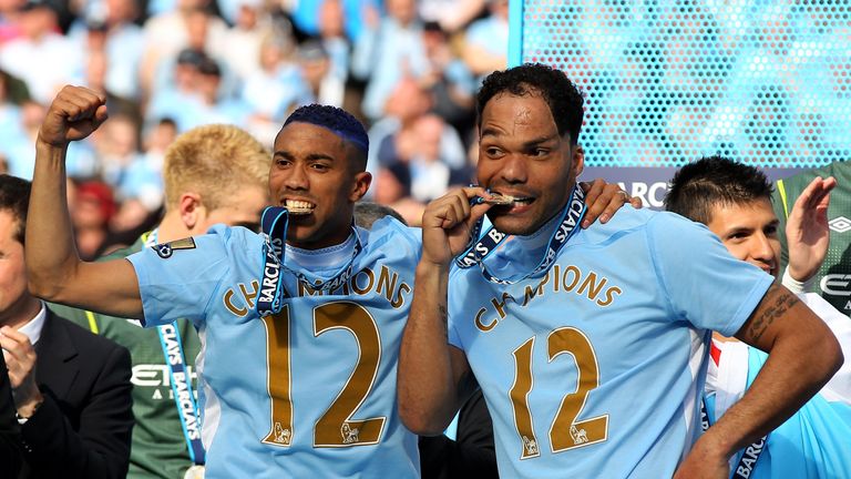 Gael Clichy and Joleon Lescott of Manchester City celebrate  after winning the Premier League