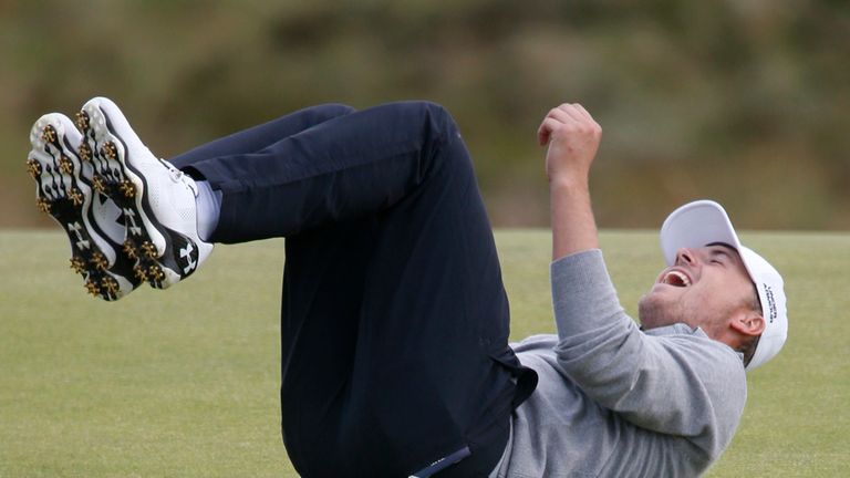 Laying down on the job: Spieth finds the funny side after missing a putt on the fifth green. 